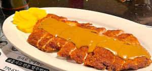 Golden-fried pork cutlet with savory sauce, a customer favorite at this top Korean restaurant in Duluth, GA.