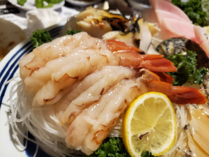 Shrimp and fish sashimi paired with lemon, highlighting the best seafood offerings in Duluth sushi restaurant.